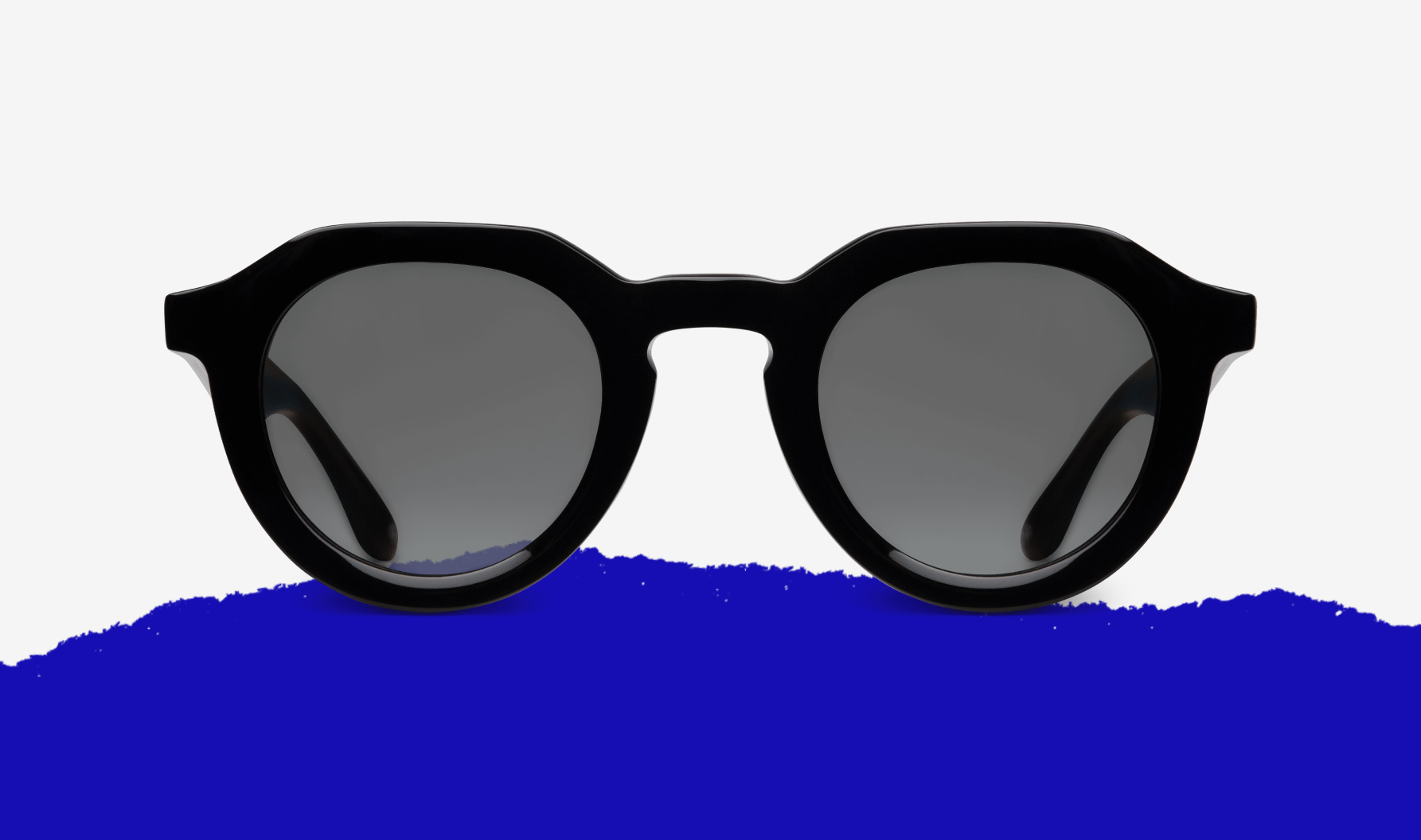 Nalta 48 Northern Black Matte with Black lens on top of EOE Eyewear's iconic blue mountain